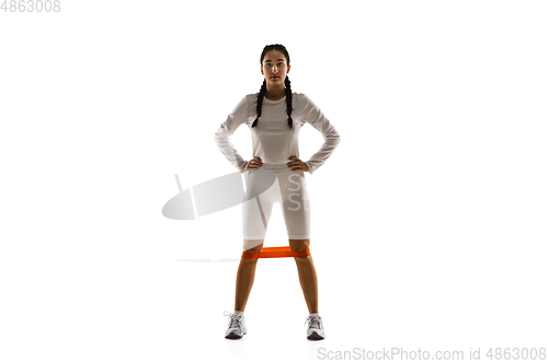 Image of Young caucasian female model in action, motion isolated on white background. Concept of sport, movement, energy and dynamic, healthy lifestyle. Training, practicing.