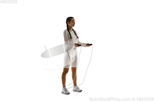Image of Young caucasian female model in action, motion isolated on white background. Concept of sport, movement, energy and dynamic, healthy lifestyle. Training, practicing.