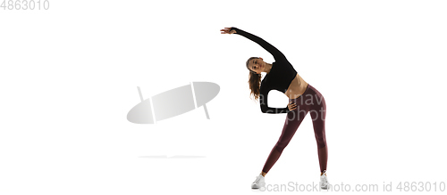 Image of Young caucasian female model in action, motion isolated on white background. Concept of sport, movement, energy and dynamic, healthy lifestyle. Training, practicing.