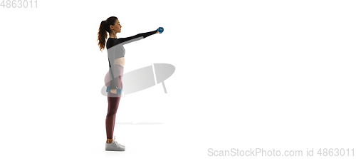 Image of Young caucasian female model in action, motion isolated on white background. Concept of sport, movement, energy and dynamic, healthy lifestyle. Training, practicing.