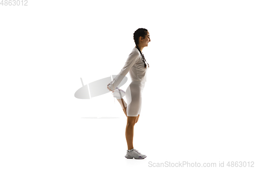 Image of Young caucasian female model in action, motion isolated on white background. Concept of sport, movement, energy and dynamic, healthy lifestyle. Training, practicing.