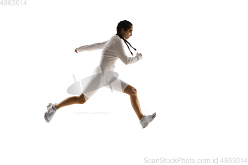 Image of Young caucasian female model in action, motion isolated on white background. Concept of sport, movement, energy and dynamic, healthy lifestyle. Training, practicing.