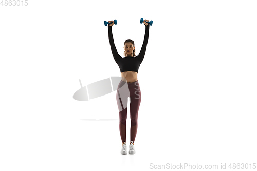 Image of Young caucasian female model in action, motion isolated on white background. Concept of sport, movement, energy and dynamic, healthy lifestyle. Training, practicing.