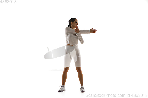 Image of Young caucasian female model in action, motion isolated on white background. Concept of sport, movement, energy and dynamic, healthy lifestyle. Training, practicing.