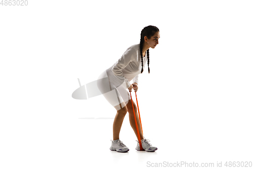 Image of Young caucasian female model in action, motion isolated on white background. Concept of sport, movement, energy and dynamic, healthy lifestyle. Training, practicing.