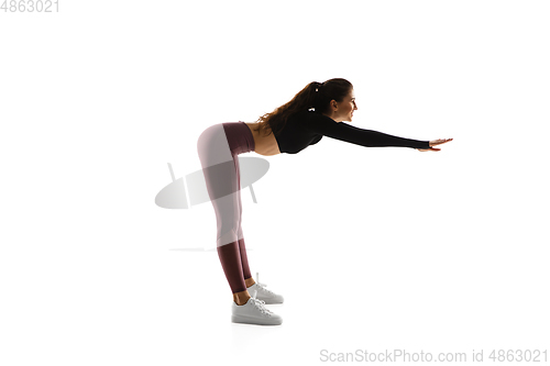 Image of Young caucasian female model in action, motion isolated on white background. Concept of sport, movement, energy and dynamic, healthy lifestyle. Training, practicing.