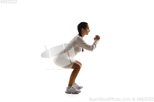 Image of Young caucasian female model in action, motion isolated on white background. Concept of sport, movement, energy and dynamic, healthy lifestyle. Training, practicing.