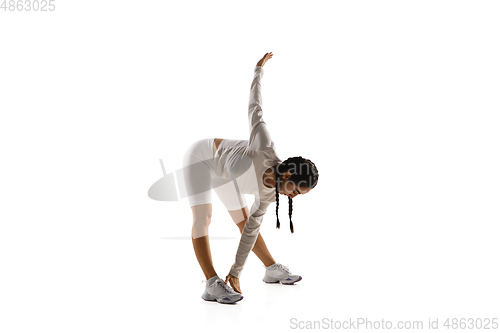 Image of Young caucasian female model in action, motion isolated on white background. Concept of sport, movement, energy and dynamic, healthy lifestyle. Training, practicing.