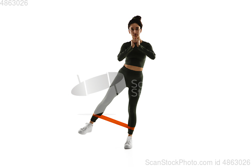 Image of Young caucasian female model in action, motion isolated on white background. Concept of sport, movement, energy and dynamic, healthy lifestyle. Training, practicing.