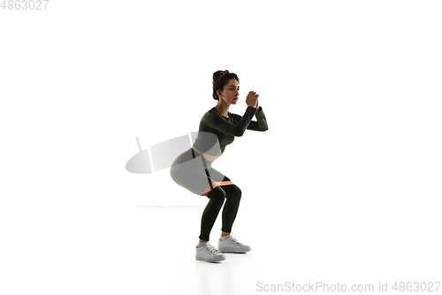 Image of Young caucasian female model in action, motion isolated on white background. Concept of sport, movement, energy and dynamic, healthy lifestyle. Training, practicing.