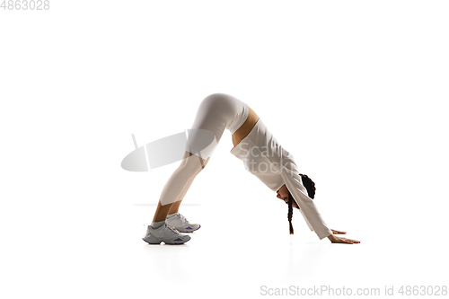 Image of Young caucasian female model in action, motion isolated on white background. Concept of sport, movement, energy and dynamic, healthy lifestyle. Training, practicing.