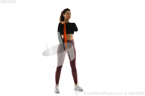 Image of Young caucasian female model in action, motion isolated on white background. Concept of sport, movement, energy and dynamic, healthy lifestyle. Training, practicing.