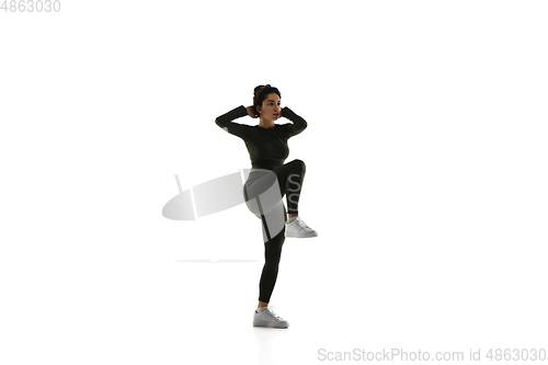 Image of Young caucasian female model in action, motion isolated on white background. Concept of sport, movement, energy and dynamic, healthy lifestyle. Training, practicing.