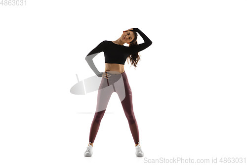 Image of Young caucasian female model in action, motion isolated on white background. Concept of sport, movement, energy and dynamic, healthy lifestyle. Training, practicing.