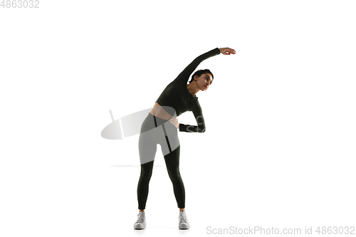 Image of Young caucasian female model in action, motion isolated on white background. Concept of sport, movement, energy and dynamic, healthy lifestyle. Training, practicing.