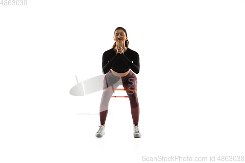 Image of Young caucasian female model in action, motion isolated on white background. Concept of sport, movement, energy and dynamic, healthy lifestyle. Training, practicing.