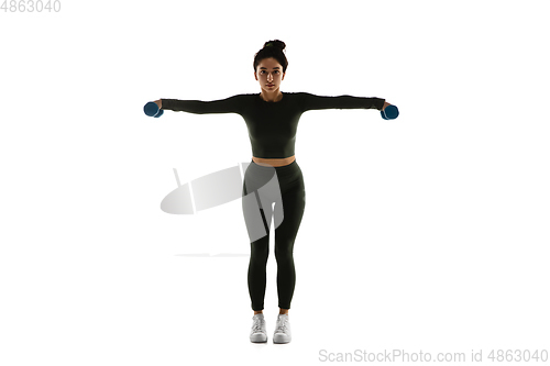 Image of Young caucasian female model in action, motion isolated on white background. Concept of sport, movement, energy and dynamic, healthy lifestyle. Training, practicing.