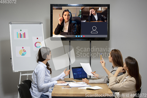 Image of Brainstorm. Young colleagues talking, working in videoconference with co-workers at office or living room. Online business, education during quarantine.
