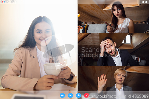 Image of Young colleagues talking, working in videoconference with co-workers at office or living room. Online business, education during quarantine.