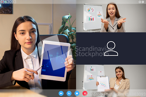 Image of Young women talking, working in videoconference with co-workers at office or living room. Online business, education during quarantine.