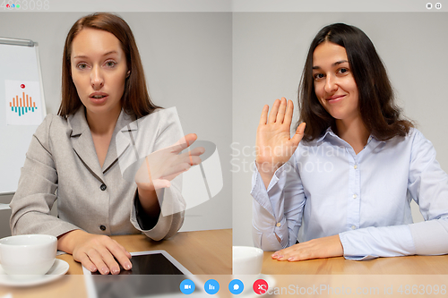 Image of Young women talking, working in videoconference with co-workers at office or living room. Online business, education during quarantine.