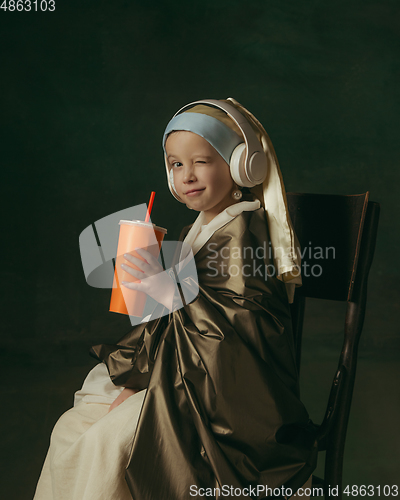 Image of Medieval little girl as a lady with a pearl earring on dark studio background. Concept of comparison of eras, childhood. Stylish creative design, art vision, new look of artwork.