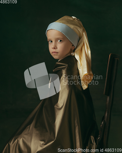 Image of Medieval little girl as a lady with a pearl earring on dark studio background. Concept of comparison of eras, childhood. Stylish creative design, art vision, new look of artwork.