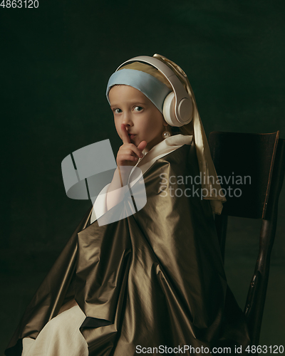 Image of Medieval little girl as a lady with a pearl earring on dark studio background. Concept of comparison of eras, childhood. Stylish creative design, art vision, new look of artwork.