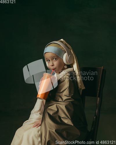 Image of Medieval little girl as a lady with a pearl earring on dark studio background. Concept of comparison of eras, childhood. Stylish creative design, art vision, new look of artwork.