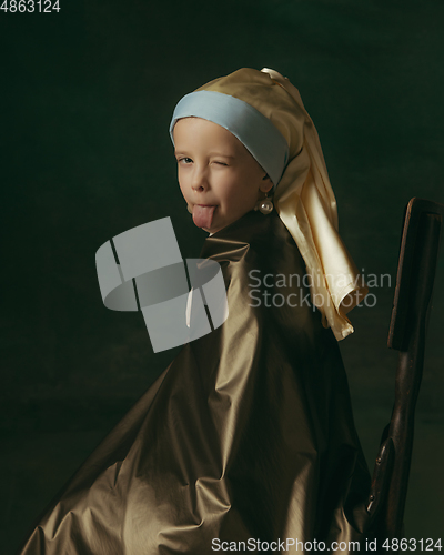 Image of Medieval little girl as a lady with a pearl earring on dark studio background. Concept of comparison of eras, childhood. Stylish creative design, art vision, new look of artwork.