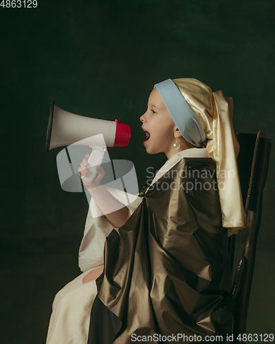 Image of Medieval little girl as a lady with a pearl earring on dark studio background. Concept of comparison of eras, childhood. Stylish creative design, art vision, new look of artwork.