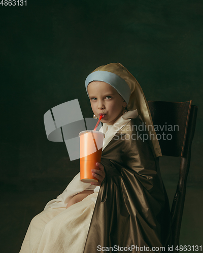 Image of Medieval little girl as a lady with a pearl earring on dark studio background. Concept of comparison of eras, childhood. Stylish creative design, art vision, new look of artwork.