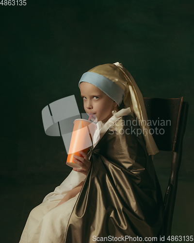 Image of Medieval little girl as a lady with a pearl earring on dark studio background. Concept of comparison of eras, childhood. Stylish creative design, art vision, new look of artwork.