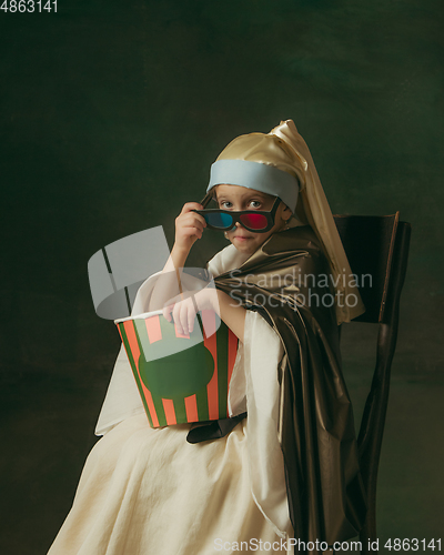 Image of Medieval little girl as a lady with a pearl earring on dark studio background. Concept of comparison of eras, childhood. Stylish creative design, art vision, new look of artwork.