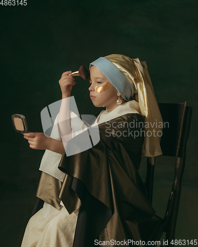 Image of Medieval little girl as a lady with a pearl earring on dark studio background. Concept of comparison of eras, childhood. Stylish creative design, art vision, new look of artwork.