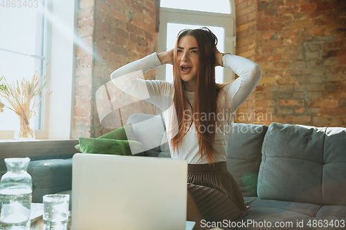 Image of Caucasian woman singing during online concert at home isolated and quarantined, impressive improvising, dancing