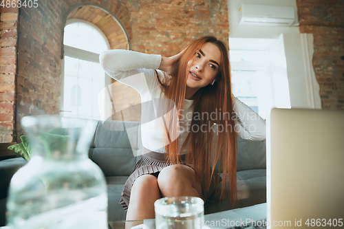 Image of Caucasian woman singing during online concert at home isolated and quarantined, impressive improvising, dancing