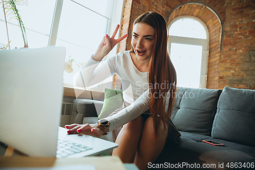 Image of Caucasian woman singing during online concert at home isolated and quarantined, tuning streaming
