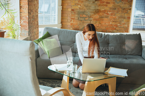 Image of Caucasian woman singing during online concert at home isolated and quarantined, impressive improvising, dancing