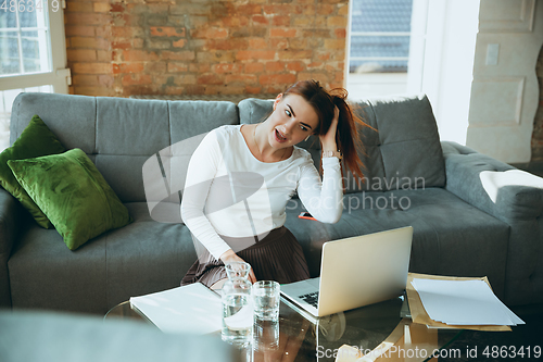 Image of Caucasian woman singing during online concert at home isolated and quarantined, impressive improvising, dancing