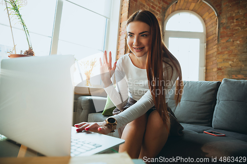 Image of Caucasian woman singing during online concert at home isolated and quarantined, greeting