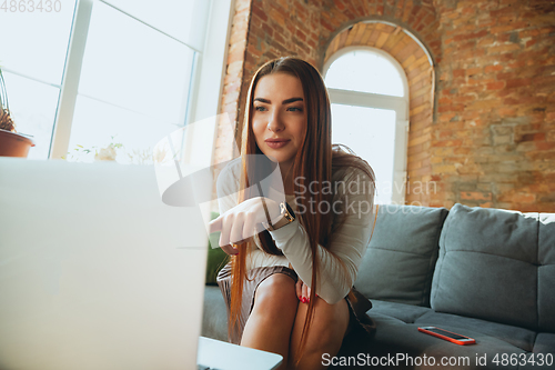 Image of Caucasian woman singing during online concert at home isolated and quarantined, impressive improvising, dancing