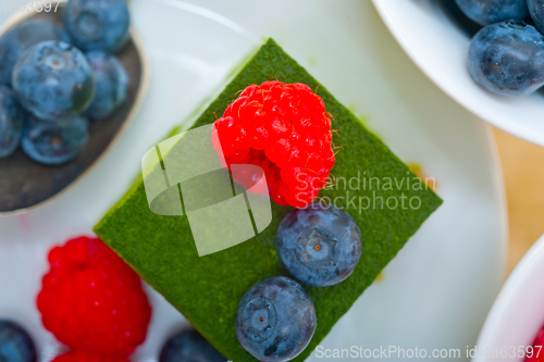 Image of green tea matcha mousse cake with berries