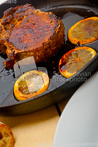 Image of pork chop seared on iron skillet
