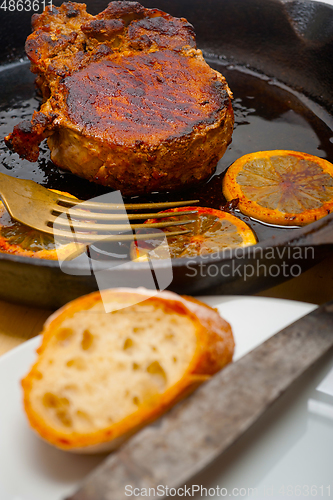 Image of pork chop seared on iron skillet