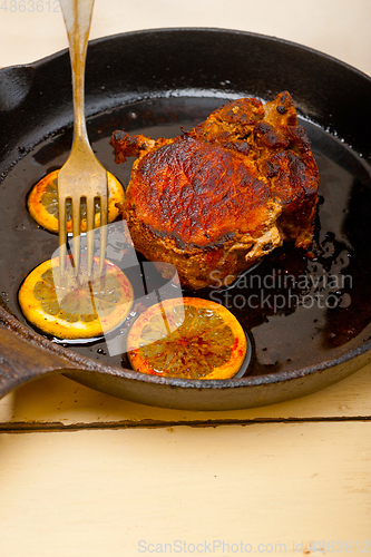 Image of pork chop seared on iron skillet