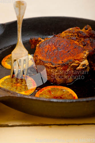 Image of pork chop seared on iron skillet