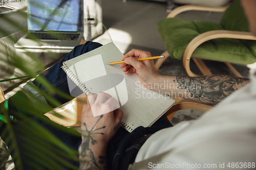 Image of Close up of male hands writing on an empty paper, education and business concept