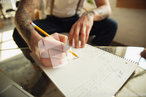 Image of Close up of male hands writing on an empty paper, education and business concept