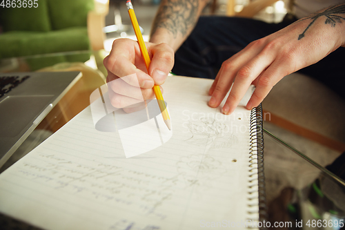 Image of Close up of male hands writing on an empty paper, education and business concept